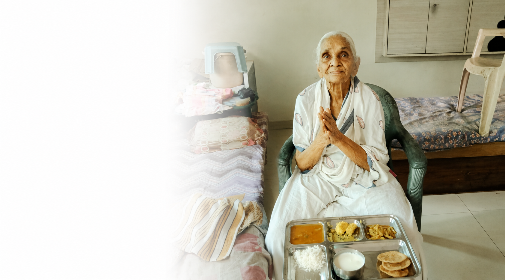 Resident offering namaste after a meal